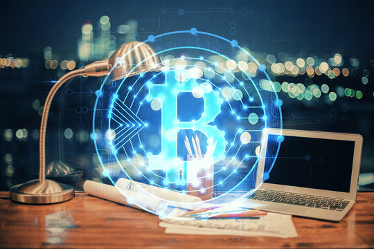 Double exposure of blockchain theme hologram and table with computer background. Concept of bitcoin crypto currency.