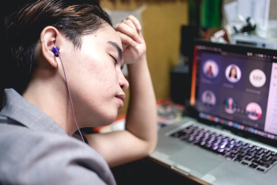 A Female Teacher Falls Asleep During An Online Conference With Other Teachers. Concept Of Stress And Fatigue During Work At Home.