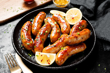 Homemade chicken  sausages fried and stewed in garlic butter sauce.