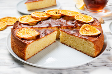 Sliced Semolina cake decorated with dried orange slices.