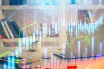Fototapeta premium Forex market graph hologram and personal computer on background. Multi exposure. Concept of investment.