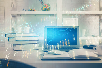 Stock market graph on background with desk and personal computer. Multi exposure. Concept of financial analysis.