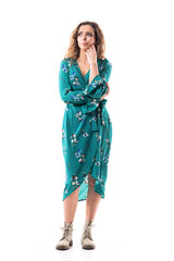 Worried and concerned young emotional woman looking up in hope with hand on cheek. Full body portrait isolated on white background