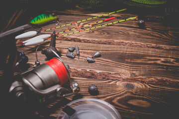 Fishing tackle on a wooden background. Studio photo.