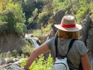 Woman with hat doing the Borosa river trail in Cazorla Natural Park

