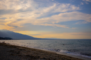 Fototapeta na wymiar sunny cloudy sunset on the beach