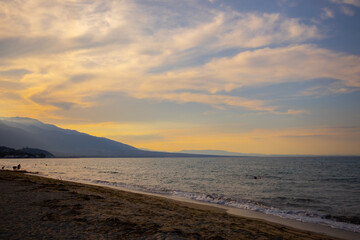 Fototapeta na wymiar warm sunny cloudy sunset on the beach