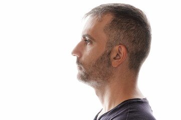 Obraz premium Man portrait. Side view of young caucasian guy in blue shirt looking forward, on the white background
