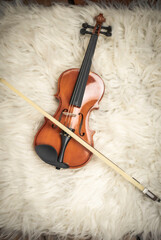 Fototapeta na wymiar Violin put on bsilk vel cloth,show detail of acoustic instrument