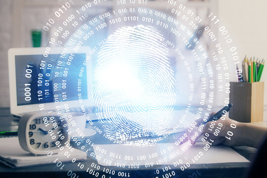 Blue fingerprint hologram over hands taking notes background. Concept of security. Double exposure