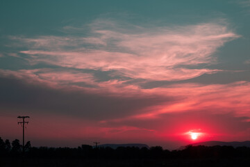 beautiful pink cloudy sunset at the fields 
