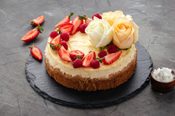 Curd cheesecake decorated with berries and roses