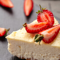 Closeup on curd cheesecake slice with strawberries