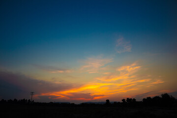 beautiful orange cloudy sunset at the fields 