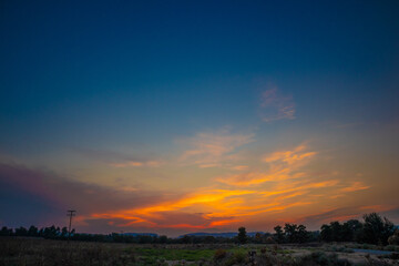 beautiful orange cloudy sunset at the fields 