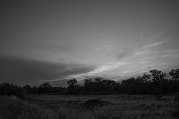 beautiful black and white cloudy sunset at the fields 