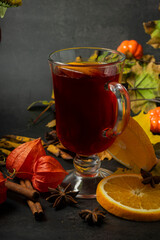 selective focus, hot drink, warmed red wine with fruit from oranges and apples, with spices of anise and cinnamon