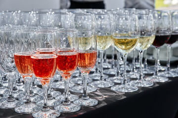 Outdoor catering banquet in summer. Сatering services. Rows of glasses with wine at restaurant party or celebration