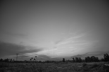 beautiful black and white cloudy sunset at the fields 