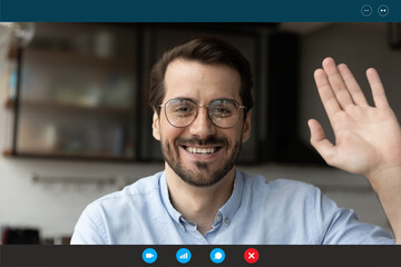 Close up screen view portrait of smiling Caucasian man wave greet speaking on video call at home....