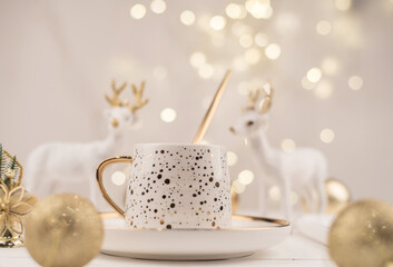 Beautiful composition with white Cup with the gold new year's drink
