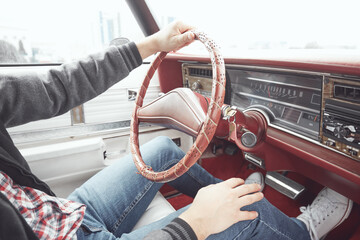 Man in retro clothes driving vintage American car.