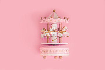 Pink baby music carousel with little horses on pink background. Gift for little girl. Decoration girls room. © Татьяна Креминская