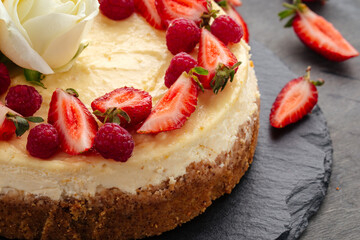 Curd cheesecake decorated with berries and roses