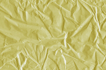 Yellow vintage and old looking crumpled paper background. Retro cardboard texture. Grunge paper for drawing. Ancient book page. Present wrapping.