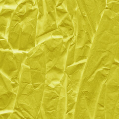 Yellow vintage and old looking crumpled paper background. Retro cardboard texture. Grunge paper for drawing. Ancient book page. Present wrapping.