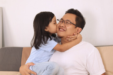 Asian father smiling while playing with his baby girl, dad and daughter love each other, happy single parent