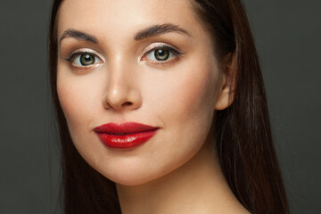Pretty woman face with perfect makeup close up. Red lips, golden eyeshadow and black eyeliner