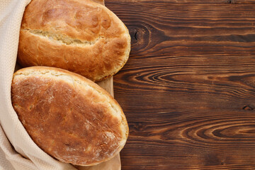 Fresh homemade wheat bread on  wooden table.