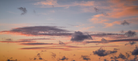 Pink clouds in orange sunset at the beach in summer