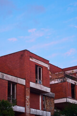 Abandoned red brick building with white lines