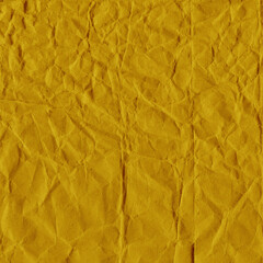 Yellow vintage and old looking crumpled paper background. Retro cardboard texture. Grunge paper for drawing. Ancient book page. Present wrapping.