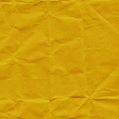 Yellow vintage and old looking crumpled paper background. Retro cardboard texture. Grunge paper for drawing. Ancient book page. Present wrapping.