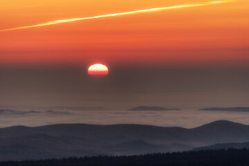 Sunset in the mountains, the sun sets over the horizon