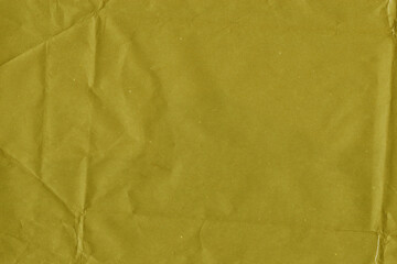 Yellow vintage and old looking crumpled paper background. Retro cardboard texture. Grunge paper for drawing. Ancient book page. Present wrapping.