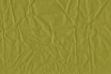 Yellow vintage and old looking crumpled paper background. Retro cardboard texture. Grunge paper for drawing. Ancient book page. Present wrapping.