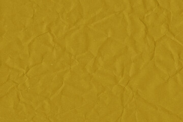 Yellow vintage and old looking crumpled paper background. Retro cardboard texture. Grunge paper for drawing. Ancient book page. Present wrapping.