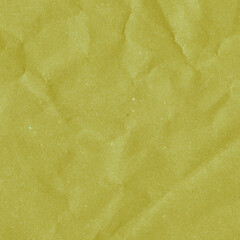 Yellow vintage and old looking crumpled paper background. Retro cardboard texture. Grunge paper for drawing. Ancient book page. Present wrapping.