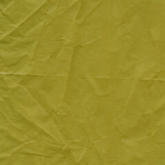 Yellow vintage and old looking crumpled paper background. Retro cardboard texture. Grunge paper for drawing. Ancient book page. Present wrapping.