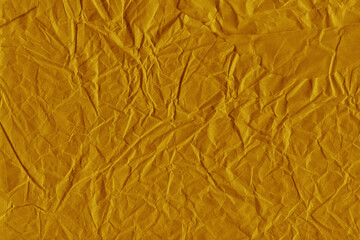 Yellow vintage and old looking crumpled paper background. Retro cardboard texture. Grunge paper for drawing. Ancient book page. Present wrapping.