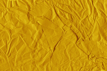 Yellow vintage and old looking crumpled paper background. Retro cardboard texture. Grunge paper for...