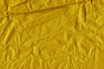 Yellow vintage and old looking crumpled paper background. Retro cardboard texture. Grunge paper for drawing. Ancient book page. Present wrapping.