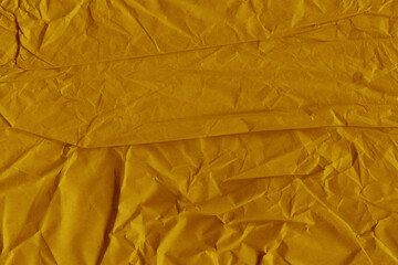 Yellow vintage and old looking crumpled paper background. Retro cardboard texture. Grunge paper for drawing. Ancient book page. Present wrapping.