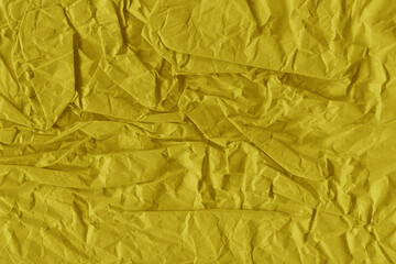 Yellow vintage and old looking crumpled paper background. Retro cardboard texture. Grunge paper for drawing. Ancient book page. Present wrapping.