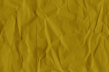 Yellow vintage and old looking crumpled paper background. Retro cardboard texture. Grunge paper for drawing. Ancient book page. Present wrapping.
