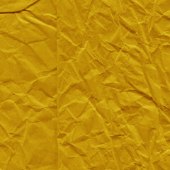 Yellow vintage and old looking crumpled paper background. Retro cardboard texture. Grunge paper for drawing. Ancient book page. Present wrapping.
